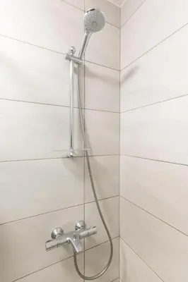 a shower with a shower head in a bathroom at Luna Penthouse Stunning Sofia Skyline plus FREE Parking in Sofia