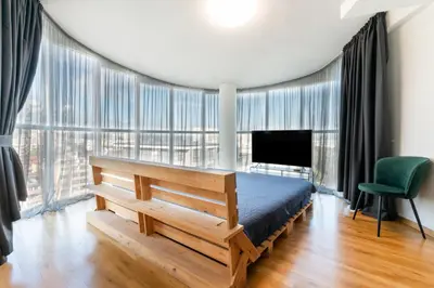 a bedroom with a bed and a large window at Luna Penthouse Stunning Sofia Skyline plus FREE Parking in Sofia