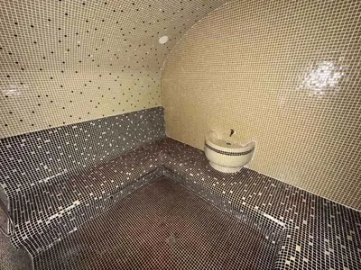 a bathroom with a tiled floor with a sink at St Ivan Rilski Spa & Pool Getaway in Bansko