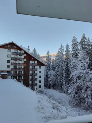 a view from a window of a building in the snow at Sunny Mountain View Villa Kometa in Pamporovo