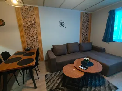 a living room with a couch and two tables at Sunny Mountain View Villa Kometa in Pamporovo