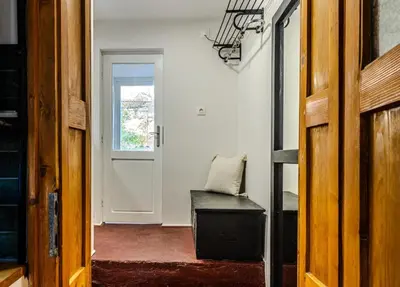 a room with a chair and a door with a window at Paganini House close to Center and Rowing Canal in Plovdiv