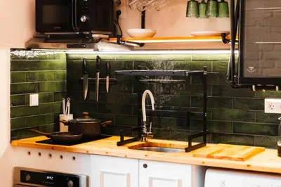 a kitchen with a sink and green tiles at Paganini House close to Center and Rowing Canal in Plovdiv
