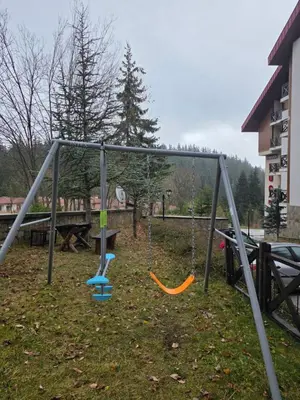 an empty swing set in a park with at Captain's Apartment in Pamporovo