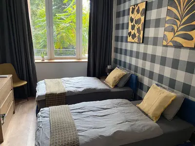 two twin beds in a room with a window at Apartment City by Wohnsol-mit Terrasse im Centrum in Sofia