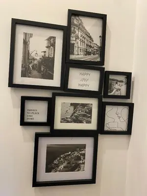 a group of framed pictures on a wall at Apartment City by Wohnsol-mit Terrasse im Centrum in Sofia
