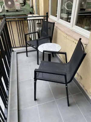 two chairs and a table on a balcony at Apartment City by Wohnsol-mit Terrasse im Centrum in Sofia