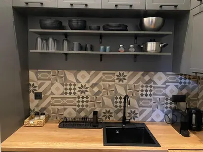 a kitchen with a sink and a tile wall at Apartment City by Wohnsol-mit Terrasse im Centrum in Sofia