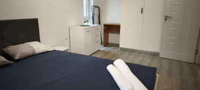 a bedroom with a bed with two white towels on it at Two-Bedroom Apartment Lauta Park 6 Plovdiv in Plovdiv
