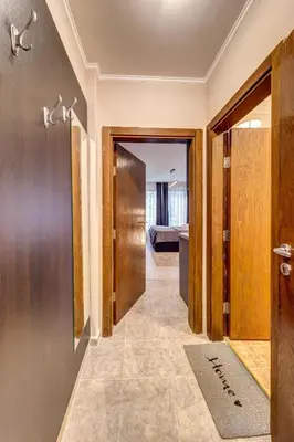 a hallway leading to a room with a bed at Studio in Dream View Resort in Pamporovo