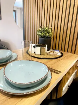 a table with plates on a wooden table at Two Modern Apartments in One Building by SI Stay in Bansko