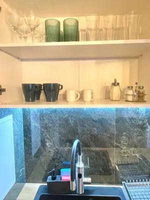 a kitchen with a sink and a counter with glasses at Two Modern Apartments in One Building by SI Stay in Bansko