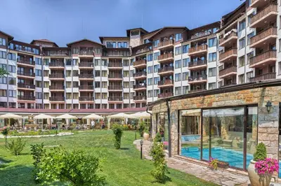 a large building with a swimming pool in a yard at Apartment VIP in Hotel Sveti Spas in Velingrad