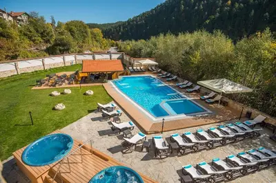an aerial view of a swimming pool with lounge chairs and a swimming pool at Apartment VIP in Hotel Sveti Spas in Velingrad