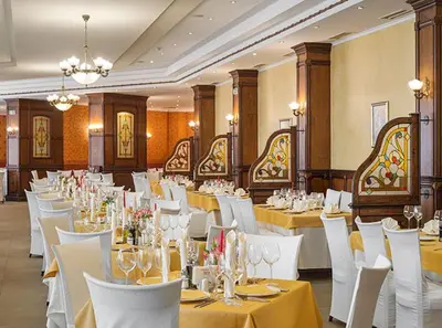a banquet hall with white tables and white chairs at Apartment VIP in Hotel Sveti Spas in Velingrad