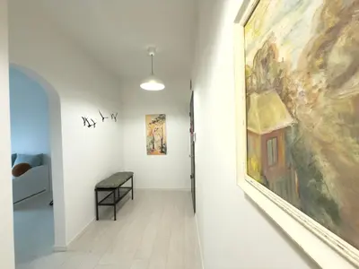 a hallway with a large painting on the wall at Sofia 3-Bedroom Mountain Family Apartment with Free Parking in Sofia