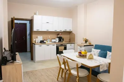 a kitchen and dining room with a table and chairs at Apartment Bee Happy, Pchelinski Bani,Hot mineral water in Pchelin