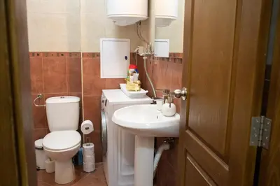 a bathroom with a toilet and a sink at Apartment Bee Happy, Pchelinski Bani,Hot mineral water in Pchelin