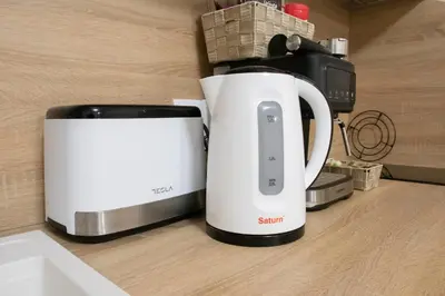 a white appliance sitting on a counter next to a toaster at Apartment Bee Happy, Pchelinski Bani,Hot mineral water in Pchelin