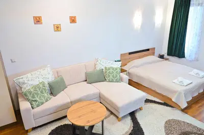 a living room with a couch and a table at Apartment Breath - Peaceful Stay Near Gondola Lift by Flat Mаnаger in Bansko