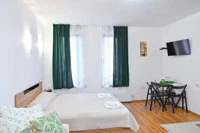 a small bedroom with a bed and a table at Apartment Breath - Peaceful Stay Near Gondola Lift by Flat Mаnаger in Bansko