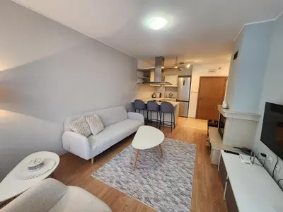 a living room with a couch and a table at Apartment Viktoria near ski lift on Pirin street in Bansko