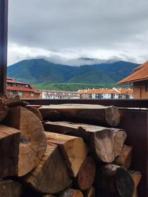 a pile of logs sitting on top of a balcony at Apartment Viktoria near ski lift on Pirin street in Bansko