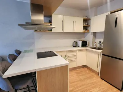 a kitchen with a white counter and a refrigerator at Apartment Viktoria near ski lift on Pirin street in Bansko