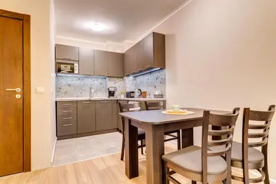 a kitchen with a table and chairs in a room at Alpine Escape at Dream View in Pamporovo