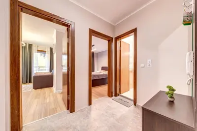 a bathroom with two mirrors and a room with a bed at Alpine Escape at Dream View in Pamporovo