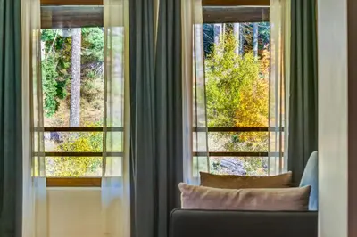 a living room with a couch and a window at Alpine Escape at Dream View in Pamporovo