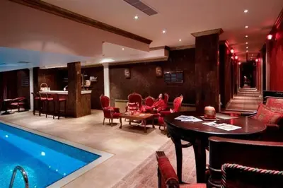 a living room with a pool and a table and chairs at Grand Monastery 3 Apartment 10 in Pamporovo