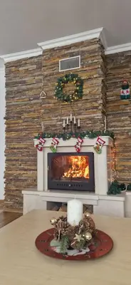 a fireplace in a living room with christmas decorations at Grand Monastery 3 Apartment 10 in Pamporovo