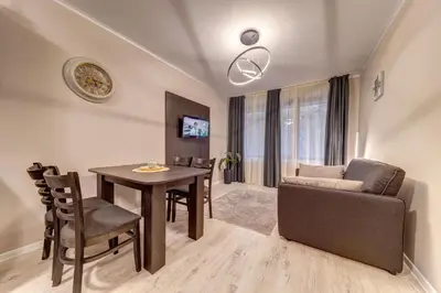 a living room with a table and a couch at Ski Slope Retreat at Dream View in Pamporovo