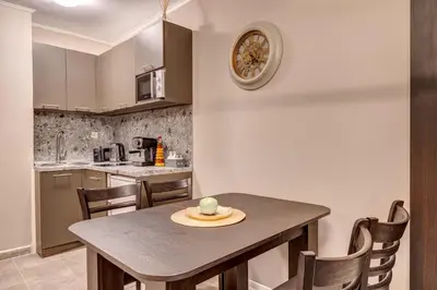 a kitchen with a table and chairs in a room at Ski Slope Retreat at Dream View in Pamporovo