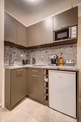 a kitchen with a sink and a microwave at Ski Slope Retreat at Dream View in Pamporovo