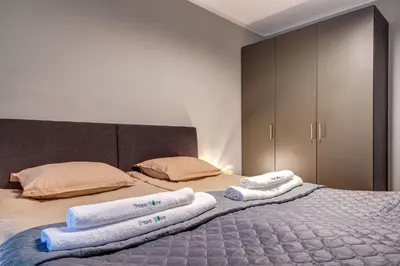 a bedroom with a bed with towels on it at Ski Slope Retreat at Dream View in Pamporovo