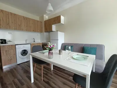 a kitchen with a white table and chairs and a kitchen with at 20th Residence Studio 11 in Sofia