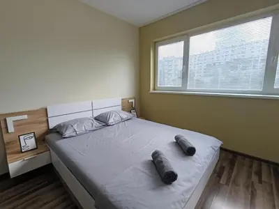 a bedroom with a large bed with two slippers on it at 20th Residence Studio 11 in Sofia