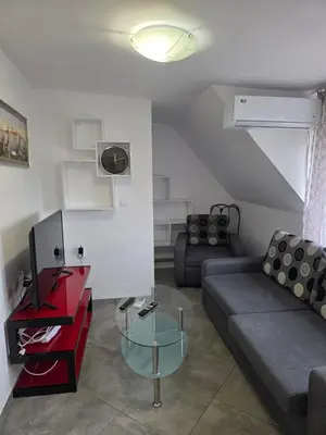 a living room with a couch and a table at Stylish 1BR near Centre in Sofia