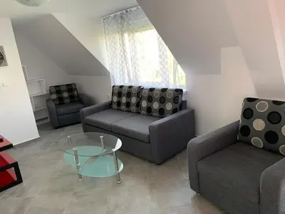 a living room with two couches and a glass table at Stylish 1BR near Centre in Sofia