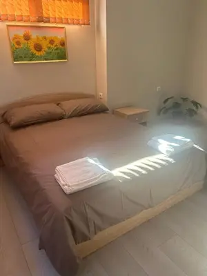 a bed with two towels on it in a bedroom at Семеен хотел Струма in Boboshevo