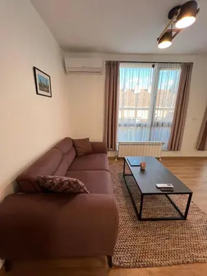 a living room with a couch and a coffee table at Marrakech Central 2BDR w Huge Terrace near Serdika in Sofia