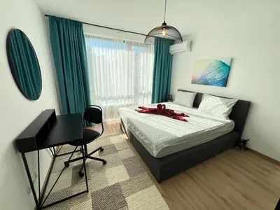 a bedroom with a bed and a desk in it at Marrakech Central 2BDR w Huge Terrace near Serdika in Sofia