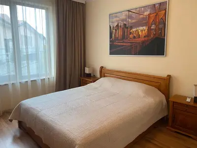 a bedroom with a bed and a large window at Cedar Lodge Apartament - Gondola in Bansko