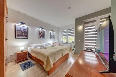 a bedroom with a bed and a tv in it at Forestside Stay at Stream Resort in Stoykite