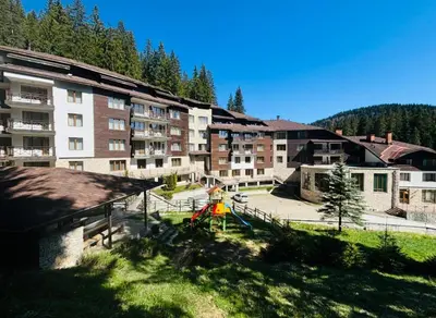 an apartment complex with a playground in front of a building at Forestside Stay at Stream Resort in Stoykite
