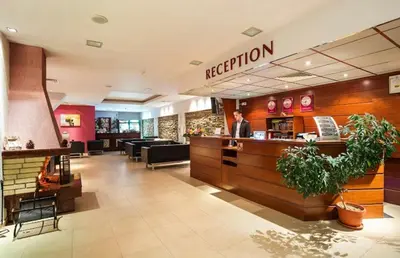 a man standing at the counter of a restaurant at Forestside Stay at Stream Resort in Stoykite