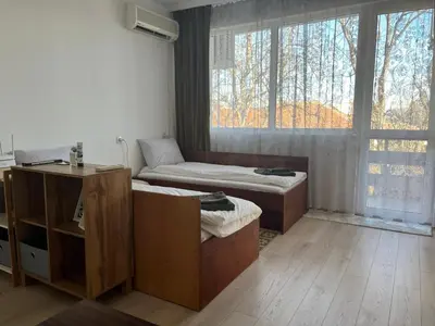 a room with a bed and a couch and a window at Cosy home in the heart of Bansko in Bansko