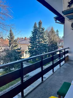 a balcony with a fence and some trees at Cosy home in the heart of Bansko in Bansko